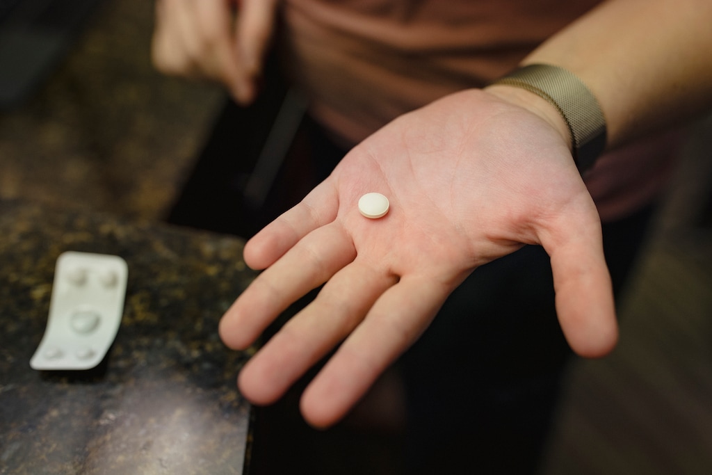(Adria Malcolm | The New York Times) Mikayla, who asked to be identified by her first name, takes mifepristone, the first pill in a two-drug regimen to end a pregnancy, at a hotel in Albuquerque, N.M., March 1, 2023. Mikayla drove from Texas to a hotel in Albuquerque to use the first telemedicine abortion service operated by a religion, one of many recent efforts to use religious freedom arguments to uphold abortion rights.