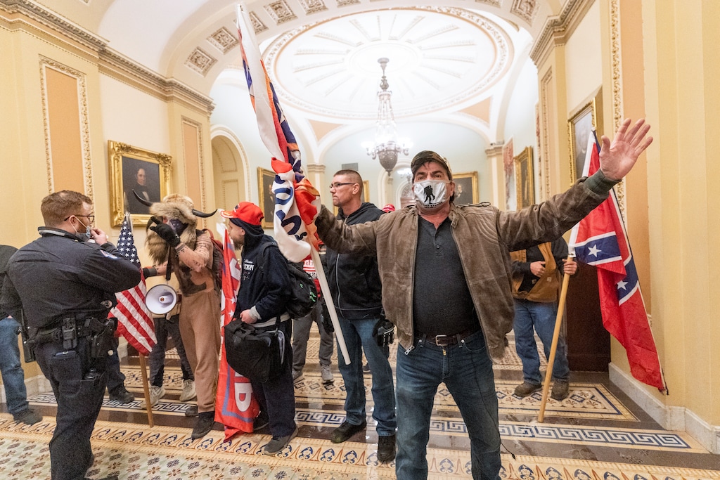 (Manuel Balce Ceneta | AP photo)
In this Jan. 6 photo, supporters of President Donald Trump are confronted by U.S. Capitol Police officers outside the Senate Chamber inside the Capitol in Washington. Both within and outside the walls of the Capitol, banners and symbols of white supremacy and anti-government extremism were displayed as an insurrectionist mob swarmed the U.S. Capitol.