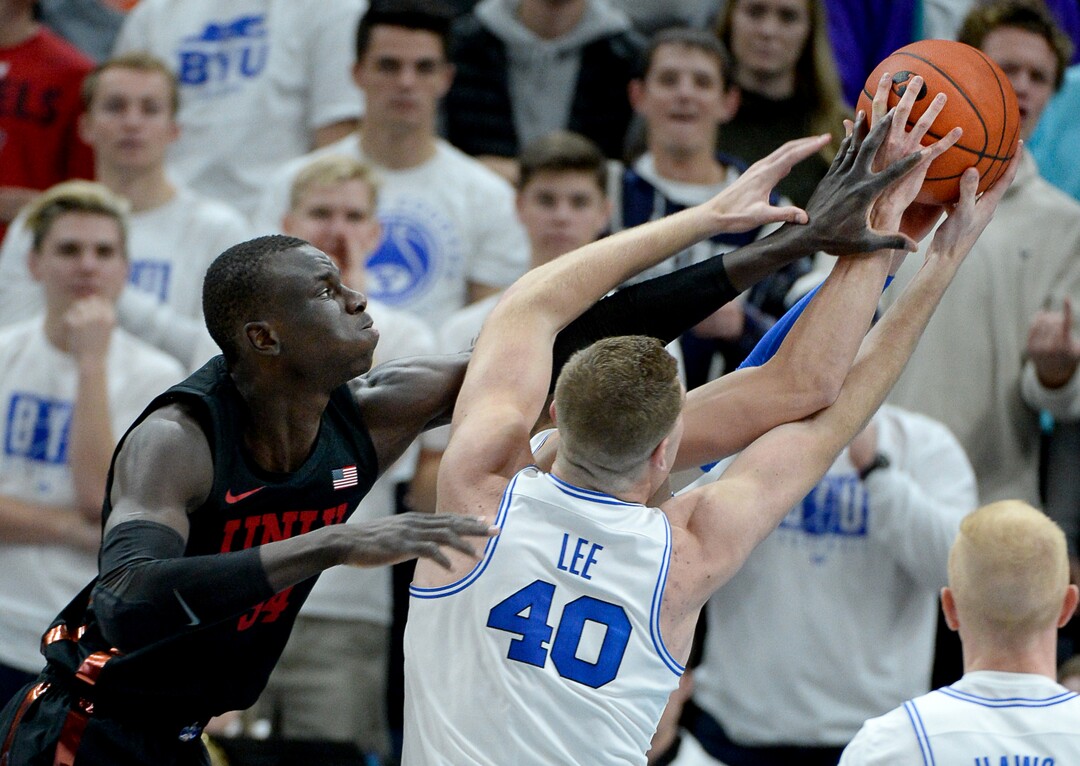 (Francisco Kjolseth  |  The Salt Lake Tribune)  UNLV Rebels forward Cheikh Mbacke Diong (34) reaches in for rebound as he battles Brigham Young Cougars forward Kolby Lee (40) and UNLV Rebels guard David Jenkins Jr. (5) as BYU takes on UNLV in men's NCAA basketball at Vivint Smart Home Arena in Salt Lake City on Sat. Dec. 7, 2019.