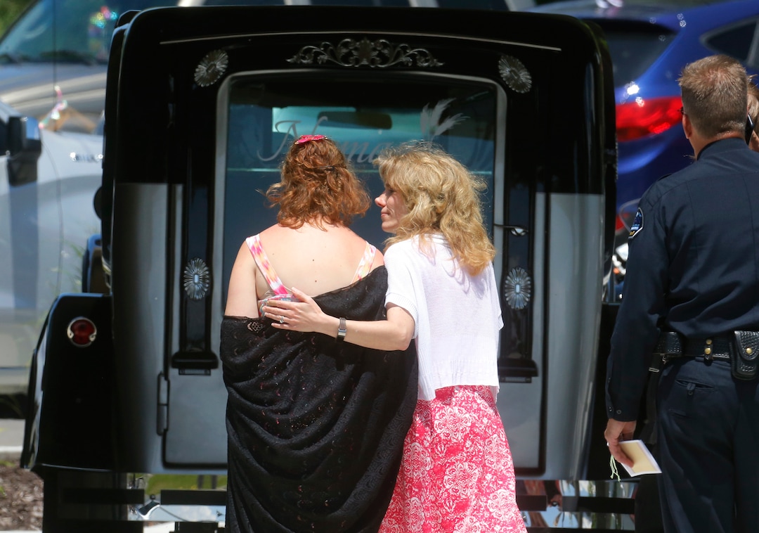 Jessica Whipple, left, is comforted as she walks past the hurst before the services at Nyman Funeral Home Tuesday, June 4, 2019, in Logan, Utah, for her daughter Elizabeth "Lizzy" Shelley, a 5-year-old girl who police say was taken from her home and killed by her uncle. Her uncle, Alex Whipple, is charged with killing her after his sister let him spend the night at the family's home, prosecutors said. Elizabeth "Lizzy" Shelley disappeared May 25 and was found dead less than a block from her home after a five-day search. (AP Photo/Rick Bowmer)