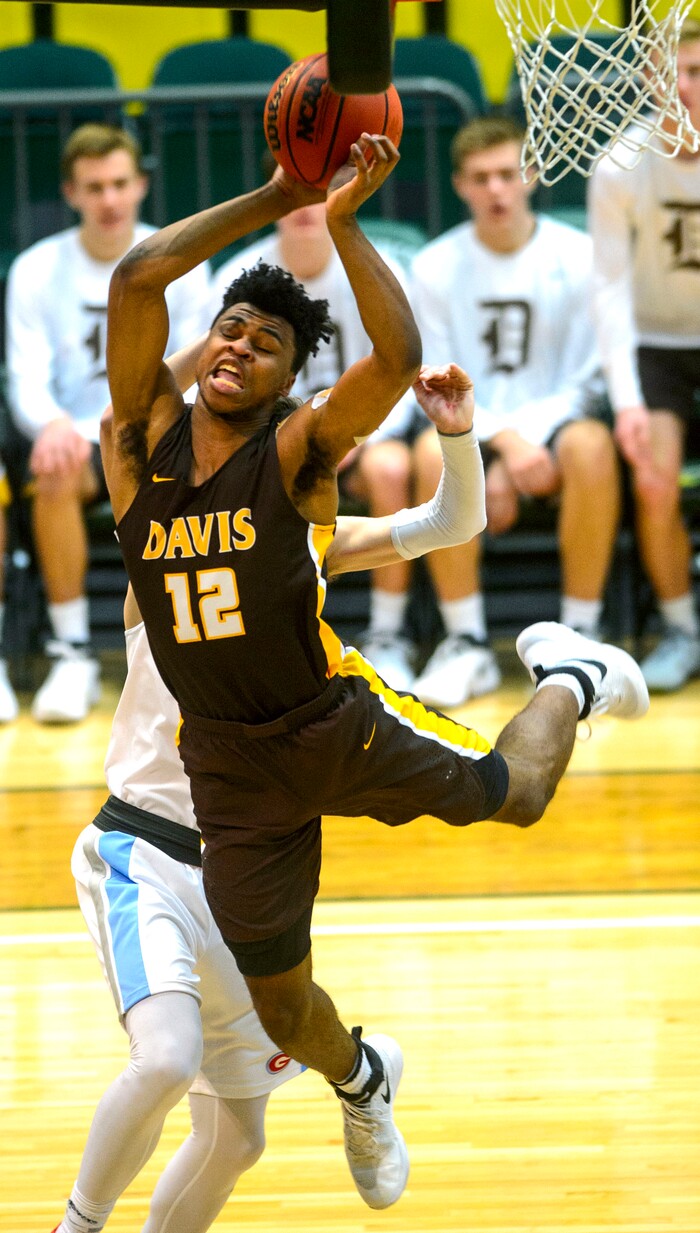 (Steve Griffin  |  The Salt Lake Tribune) Davis forward Brendon Redford gets fouled as he goes to the basket during the Granger versus Davis 6A basketball playoff game at Utah Valley UniversityÕs UCCU Center in Provo Tuesday Feb. 27, 2018.