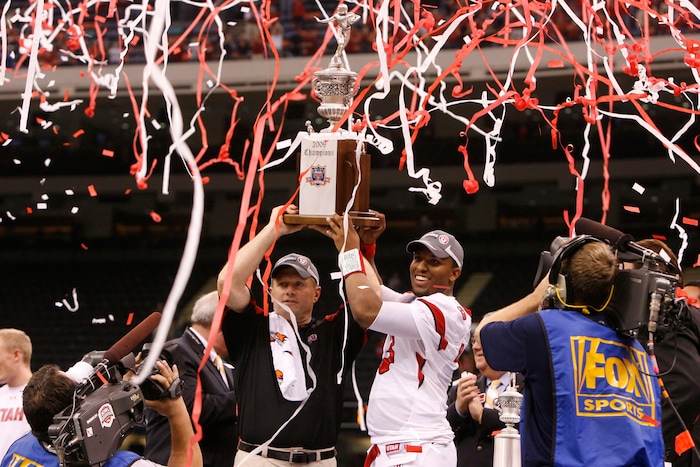(Scott Sommerdorf | The Salt Lake Tribune) Kyle Whittingham and quarterback Brian Johnson hold the Sugar Bowl trophy aloft after the Utes defeated Alabama in in New Orleans, Jan. 2, 2009.