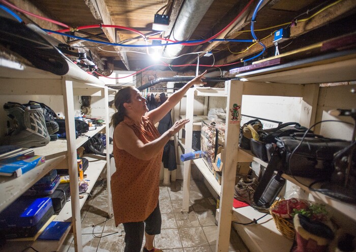 (Rick Egan  |  The Salt Lake Tribune)  Emmy Thomson shows where flood water came pouring into her basement storage room,  flooding the basement of her home on Lincoln Street. Tuesday, August 1, 2017.