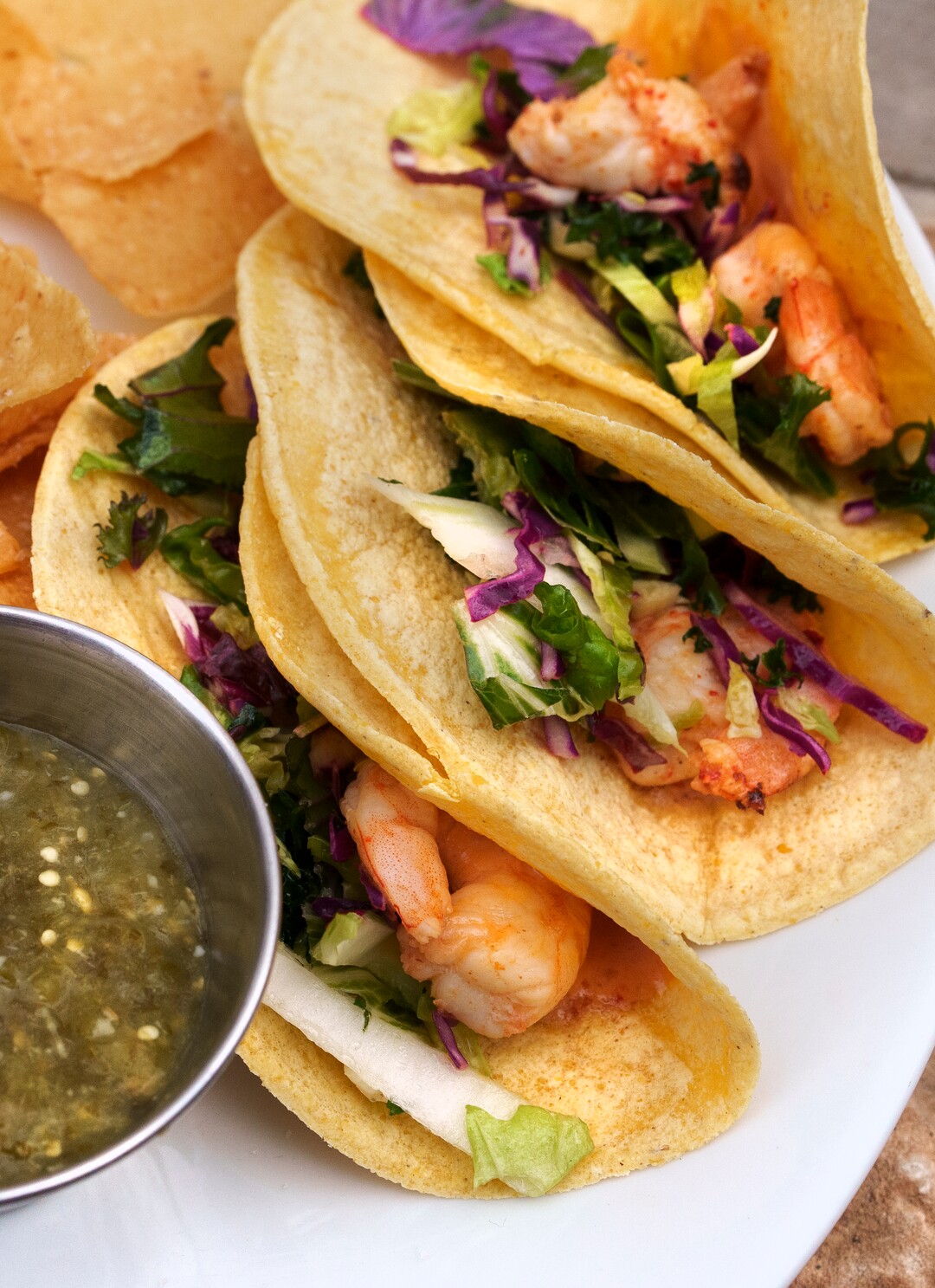 (Leah Hogsten | The Salt Lake Tribune) Emigration Cafe's Baja Shrimp Tacos with tajin marinated shrimp, cabbage slaw, pickled onions, chipotle aioli served in corn tortillas with chips, $16, April 27, 2022. Emigration Cafe's menu features Roman style wood fired pizza, salads, sandwiches and mains.