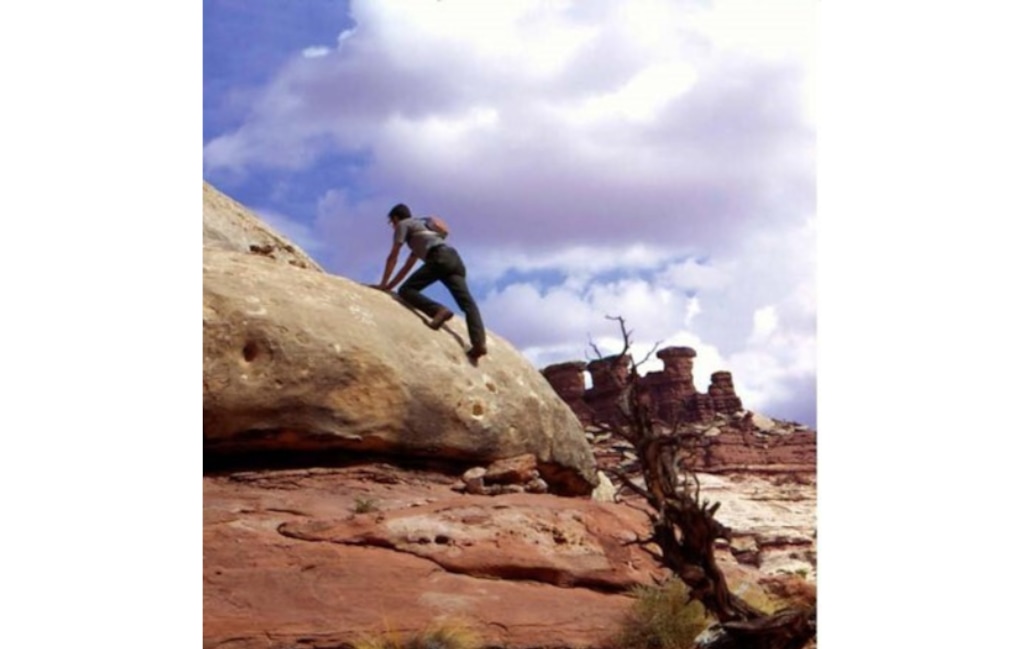 Al Hendricks, the first backcountry ranger in Canyonlands' rugged Maze District, climbs a rock in the district in 1972 in this uncredited photo. Hendricks died last month in Montana.