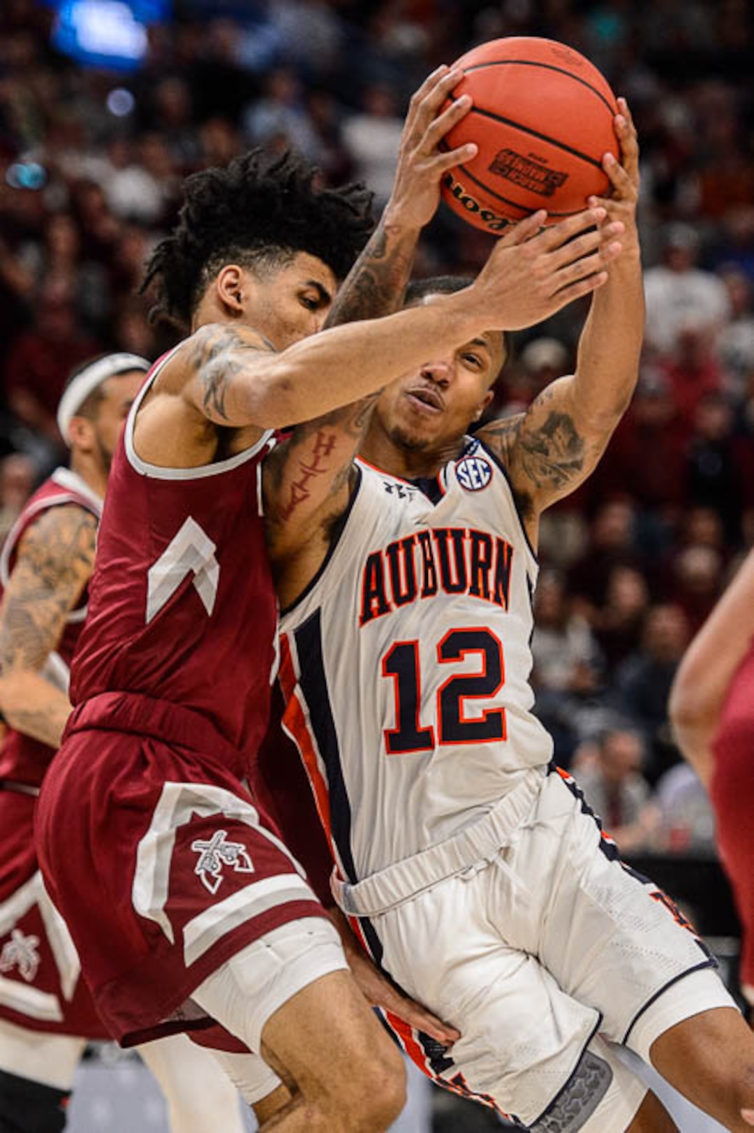 (Trent Nelson | The Salt Lake Tribune)  Auburn Tigers guard J'Von McCormick (12) runs into New Mexico State Aggies guard JoJo Zamora (4) as Auburn faces New Mexico State in the 2019 NCAA Tournament in Salt Lake City on Thursday March 21, 2019.