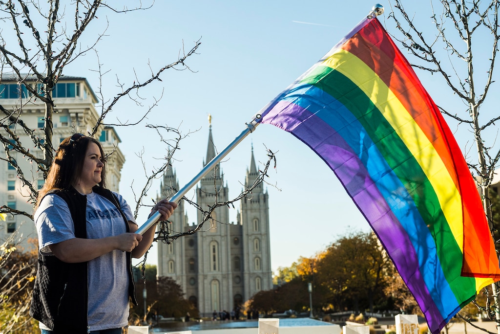 (Chris Detrick | Tribune file photo) Sandy Newcomb, of Springville, holds a rainbow flag during a Mass Resignation from the Church of Jesus Christ of Latter Day Saints near Temple Square in Salt Lake City Saturday November 14, 2015. Newcomb resigned from the Church in 2007 after being a member for over 30 years. Thousands of people gathered to protest their displeasure with the recent policy changes targeting the children of gay and lesbian couples. The attendees joined together in renouncing their membership with The Church of Jesus Christ of Latter-day Saints.
