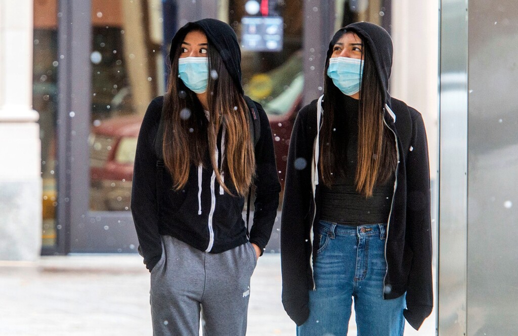 (Rick Egan | The Salt Lake Tribune)  Pedestrians wear masks as they wait for the Trax train, in downtown Salt Lake City, Monday, Nov. 9, 2020.