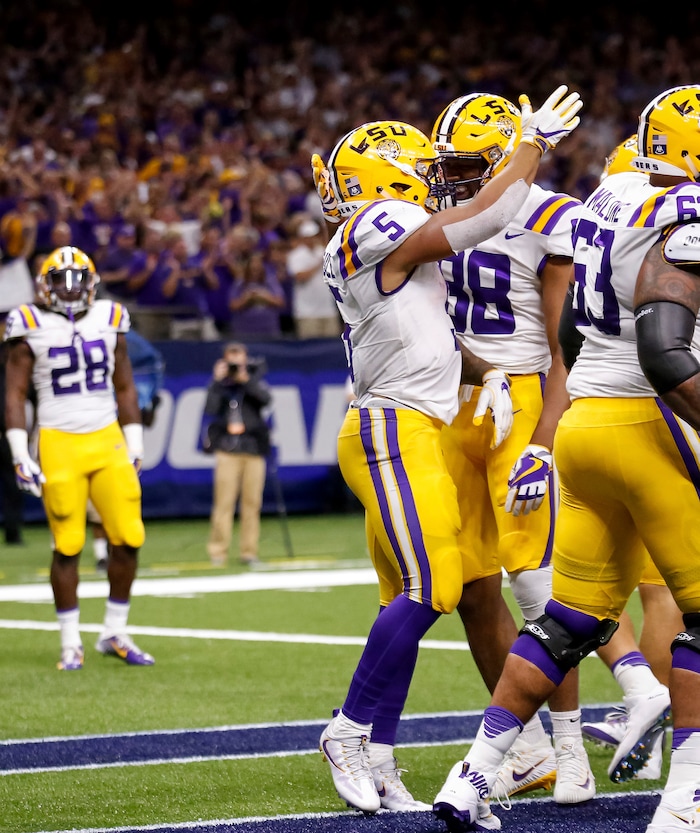 LSU running back Derrius Guice (5) and tight end Jacory Washington (88) celebrate Guice's first touchdown against BYU in the first half of an NCAA college football game in New Orleans, Saturday, Sept. 2, 2017. (AP Photo/Scott Threlkeld)