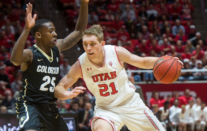 (Rick Egan  |  The Salt Lake Tribune)  Utah Utes forward Tyler Rawson (21) takes the ball inside, as Colorado Buffaloes guard McKinley Wright IV (25) defends, in PAC-12 basketball action at the Jon M. Huntsman Center, Saturday, March 3, 2018.