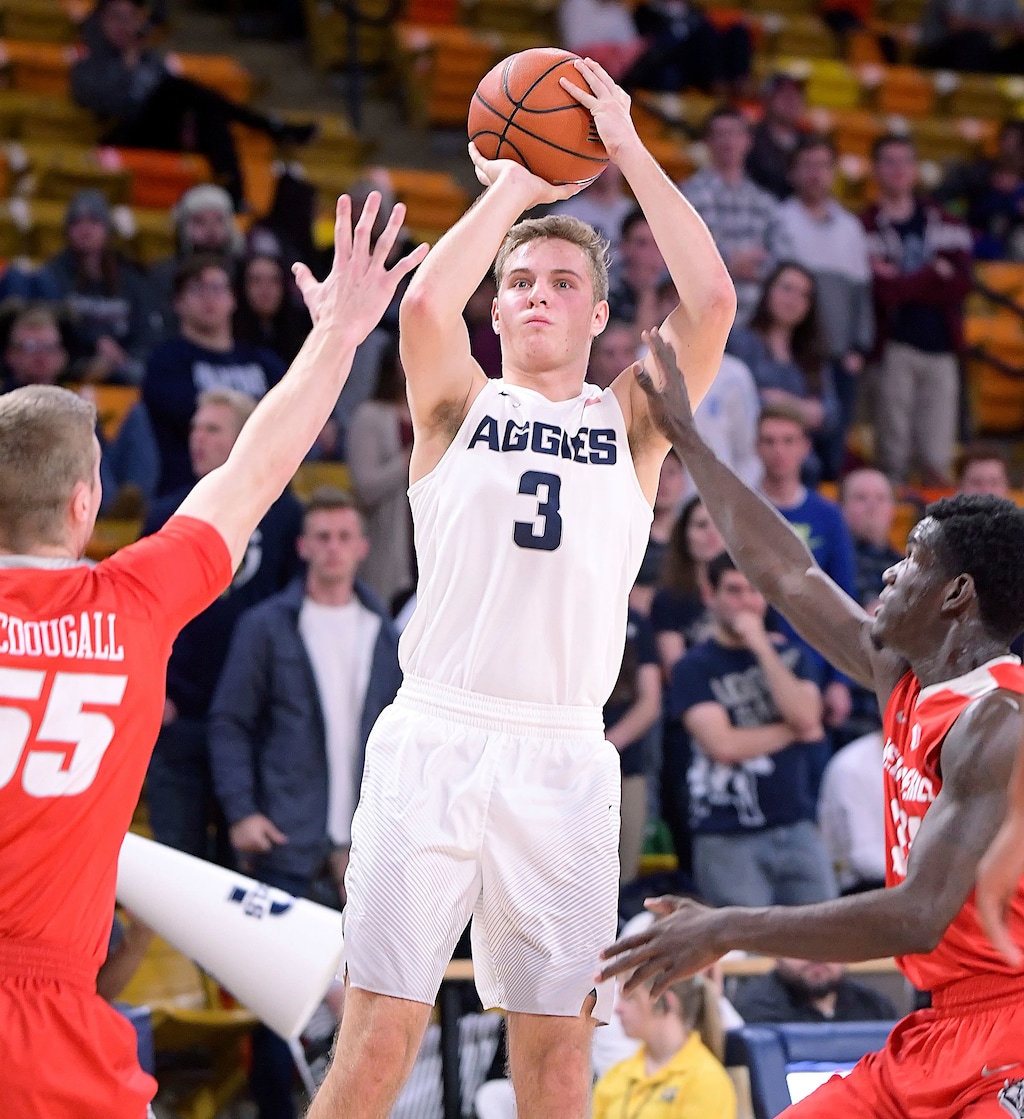 Utah State guard Sam Merrill (3) takes a shot as New Mexico forward Connor MacDougall (55) and guard Damien Jefferson (24) defend Wednesday, Jan. 4, 2017, in Logan, Utah. (Eli Lucero/The Herald Journal via AP)
