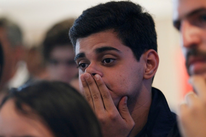 An opposition member reacts as the President of Venezuelan National Electoral Council Tibisay Lucena announces that the candidates for the ruling socialist party have won a majority of the 23 governors' offices up for grabs in regional elections at opposition headquarters in Caracas, Venezuela, Sunday, Oct 15, 2017. Pro-government electoral council president Tibisay Lucena says opposition candidates won just five of 22 races where the results are considered irreversible. (AP Photo/Ariana Cubillos)