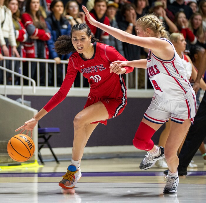 (Rick Egan | The Salt Lake Tribune) Bountiful Redhawks Taylor Harvey takes the ball inside, as Springville Red Devil Madi Galbraith defends, in the Girls 5A State Championship between the Springville Red Devils and the Bountiful Redhawks, at Weber State, on Saturday, March 4, 2023.
