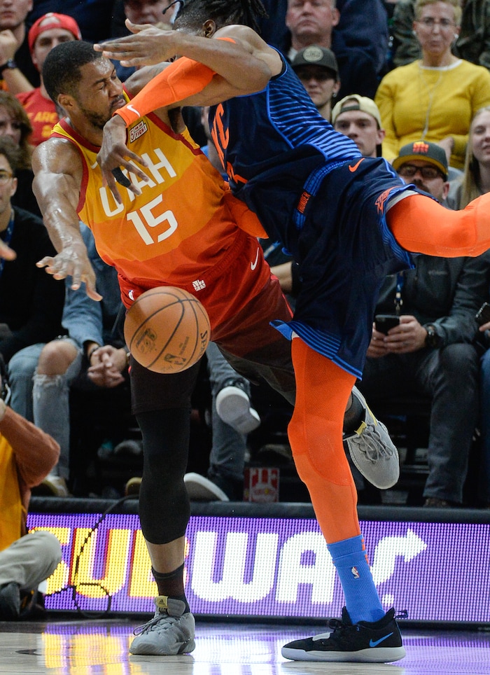 (Francisco Kjolseth  |  The Salt Lake Tribune)   Utah Jazz forward Derrick Favors (15) takes a hard hit from Oklahoma City Thunder forward Nerlens Noel (3) in the second half of the NBA game at Vivint Smart Home Arena Sat., Dec. 22, 2018, in Salt Lake City.