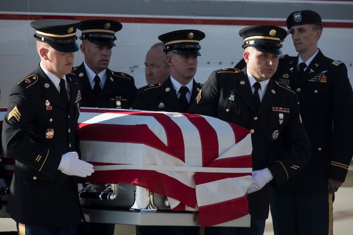 (Matt Herp | The Ogden Standrad Examiner/Pool) Utah National Guard Honor Guard Detail members carry a casket containing the remains of Maj. Brent R. Taylor at Roland R. Wright Air National Guard Base in Salt Lake City, Utah, on Wednesday, Nov. 14, 2018. Taylor, 39, of North Ogden, died Nov. 3, 2018, in Afghanistan of wounds sustained from small arms fire. His funeral is scheduled for Saturday, Nov. 17, in Ogden.