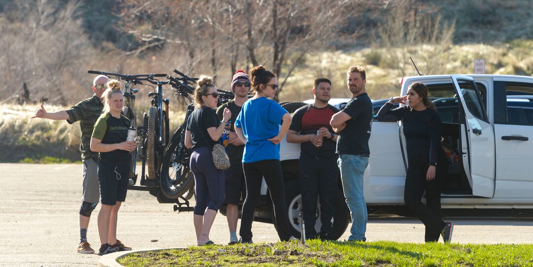 (Leah Hogsten  |  The Salt Lake Tribune) Families and friends congregate around their cars in the Rainbow Gardens gift shop and restaurant parking lot in Ogden on Sunday after hikes and bike rides in the foothills and the nearby Ogden River Trail, March 22, 2020. As the global battle against COVID-19 deepens, some Utahns have used the state's great outdoors as an alternative to isolating at home.