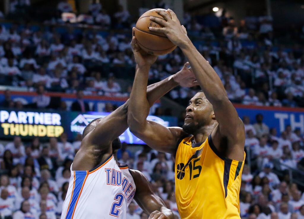 Utah Jazz forward Derrick Favors (15) goes to the basket past Oklahoma City Thunder guard Raymond Felton (2) during the second half of Game 2 of an NBA basketball first-round playoff series in Oklahoma City, Wednesday, April 18, 2018. (AP Photo/Sue Ogrocki)