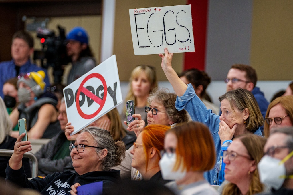 (Trent Nelson | The Salt Lake Tribune) Audience members hold signs at a joint town hall with U.S. Reps. Celeste Maloy and Mike Kennedy in Salt Lake City on Thursday, March 20, 2025.