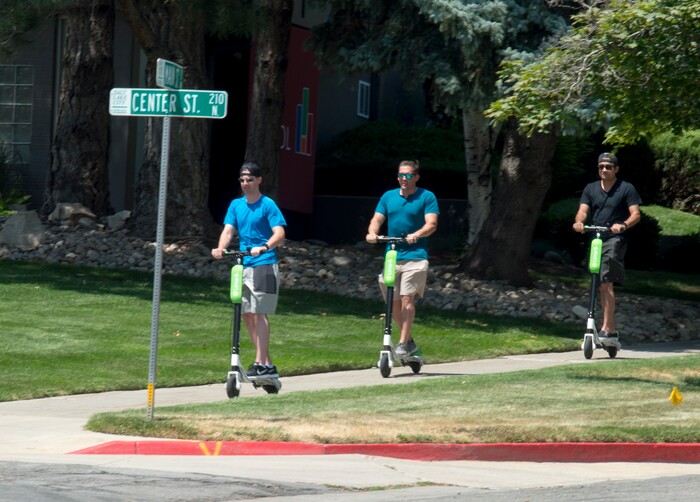 (Rick Egan  |  The Salt Lake Tribune)    James Teague, Lee Myers, and Mike Ceja, ride Lime Scooters, in downtown Salt Lake City, Monday, July 30, 2018.

 