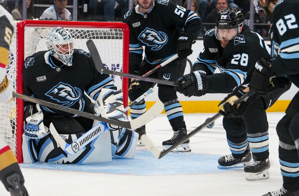 (Chris Samuels | The Salt Lake Tribune) Utah Mammoth defenders swat away the puck during Game 3 of the first round of the Stanley Cup playoffs.