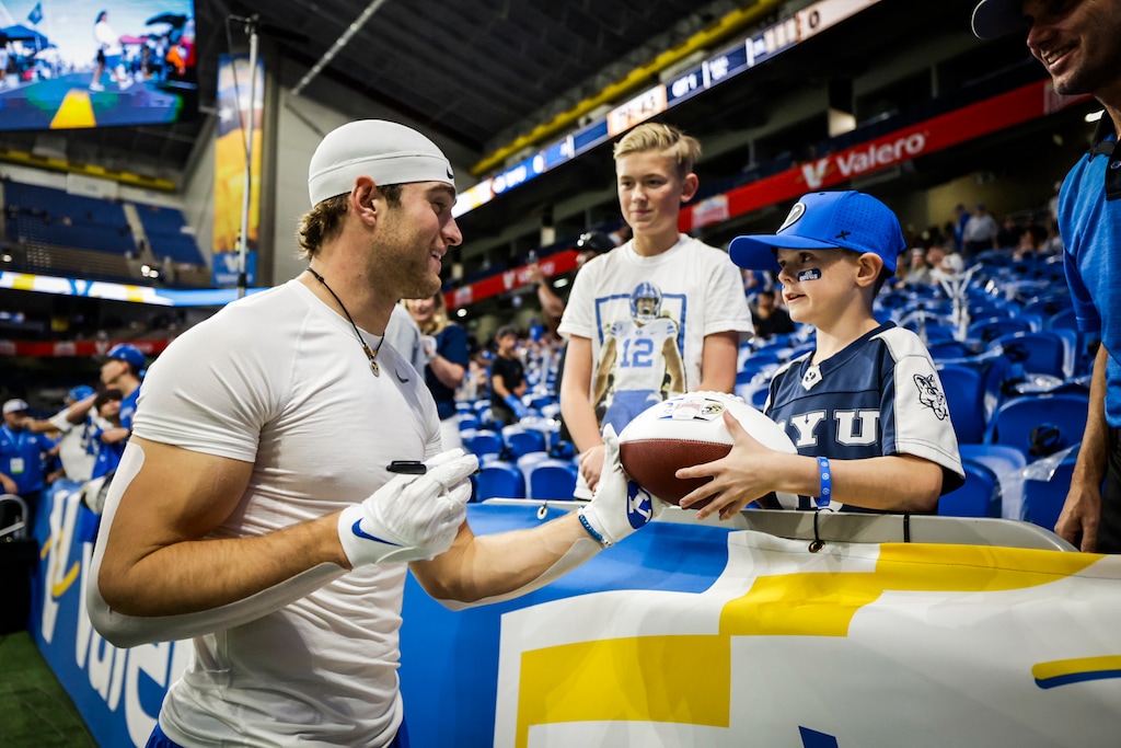 (BYU Athletics) BYU wide receiver Chase Roberts signs an autograph for a young fan ahead of the Alamo Bowl on Dec. 28, 2024.