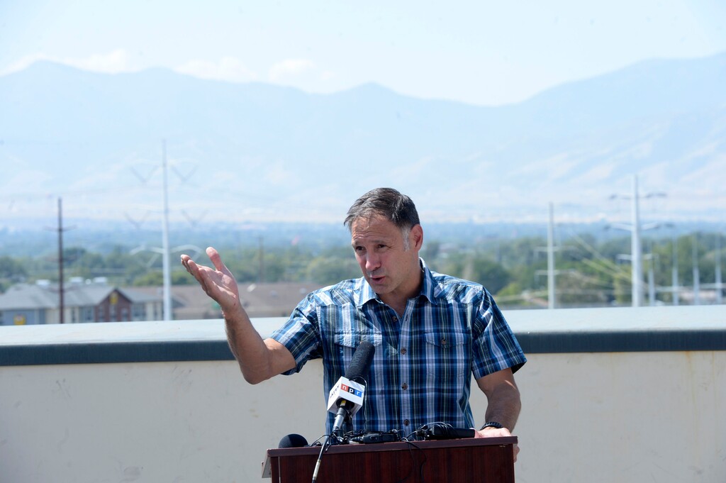 (Al Hartmann | The Salt Lake Tribune) Nazz Kurth, President of Petzl America speaks at press conference over a polluted scene from the rooftop of Petzl America building in West Valley City Tuesday Aug. 29. The Oquirrh Mountain range a few miles to the west are obsured by typical Summer pollution haze. He was among 30 Utah businesses, including Zions Bank, Mark Miller, Patagonia, and others that signed a petition today to ask the governor and legislature for more immediate action over the state's poor air quality. They contend the bad air is affecting their employees and business opportunities.