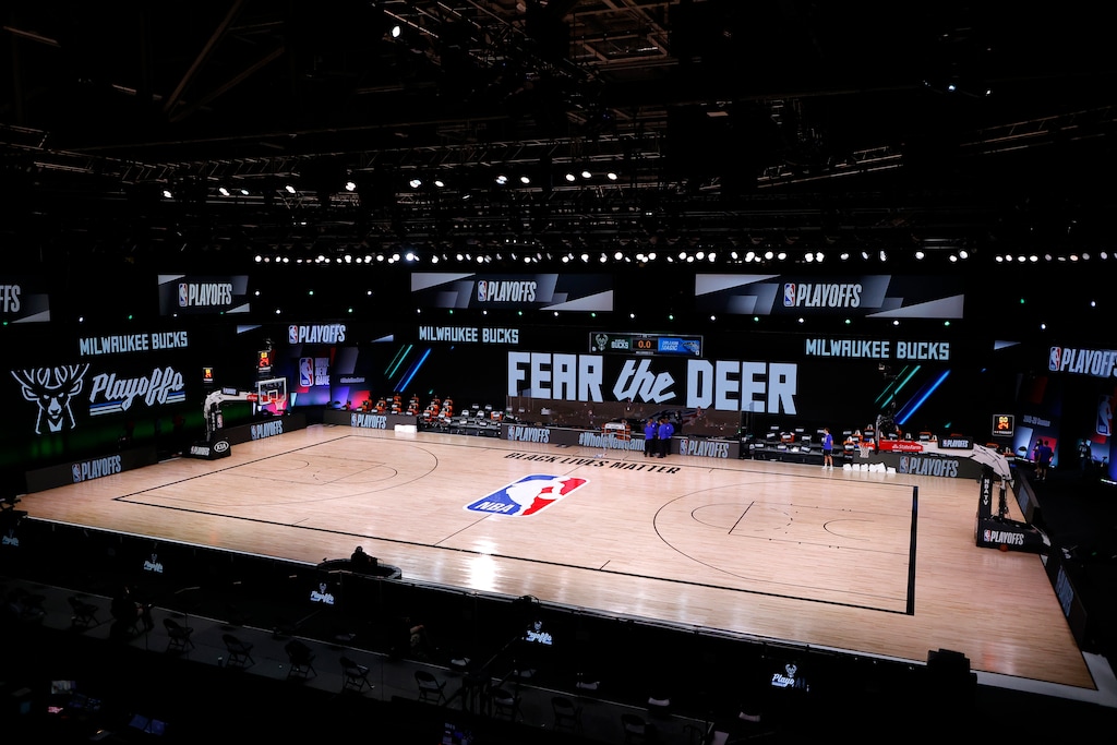 (Kevin C. Cox | Pool via AP) Referees huddle on an empty court at game time of a scheduled game between the Milwaukee Bucks and the Orlando Magic for Game 5 of an NBA basketball first-round playoff series, Wednesday, Aug. 26, 2020, in Lake Buena Vista, Fla.