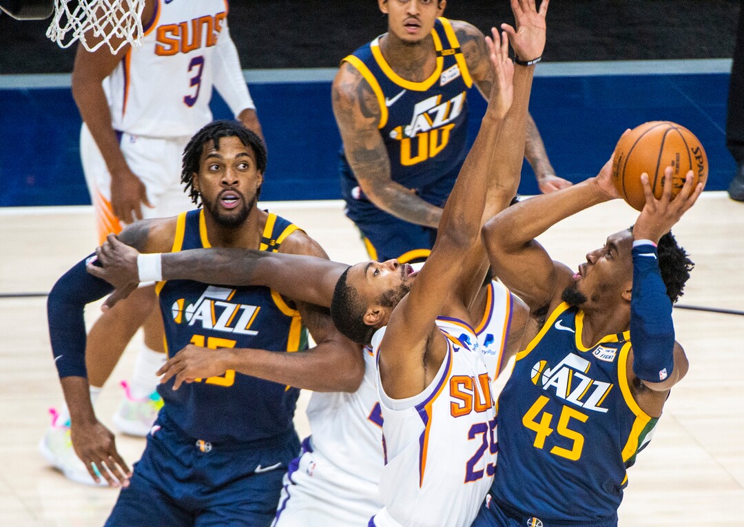 (Rick Egan | The Salt Lake Tribune) Utah Jazz guard Donovan Mitchell (45) shoots over Phoenix Suns forward Mikal Bridges (25), in NBA action between the Utah Jazz and the Phoenix Suns, on Thursday, Dec. 31, 2020.