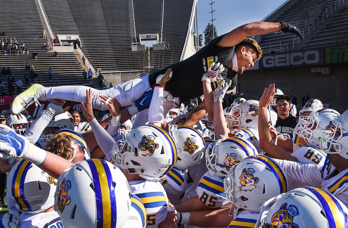 (Francisco Kjolseth  |  The Salt Lake Tribune)  Orem's Puka Nacua celebrates as he leaps over his teammates after clutching the state record for touchdowns with 26 against Dixie in the 4A high school championship game at Rice Eccles Stadium in Salt Lake City, Friday, Nov. 16, 2018.