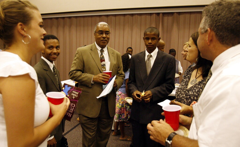 (Stephen Holt | Tribune file photo) Genesis Group President Don Harwell, center, mingles with family and friends after a fireside in Murray in 2007. Harwell died Saturday at age 75.