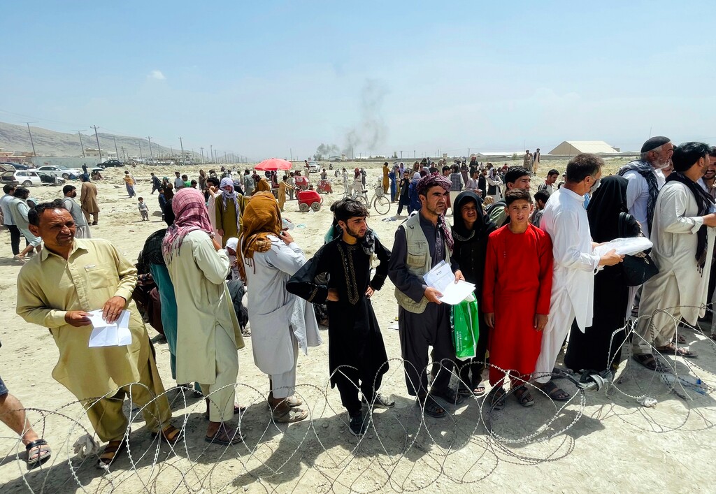 (AP) Hundreds of people gather outside the international airport in Kabul, Afghanistan, Tuesday, Aug. 17, 2021. The Taliban declared an “amnesty” across Afghanistan and urged women to join their government Tuesday, seeking to convince a wary population that they have changed a day after deadly chaos gripped the main airport as desperate crowds tried to flee the country.