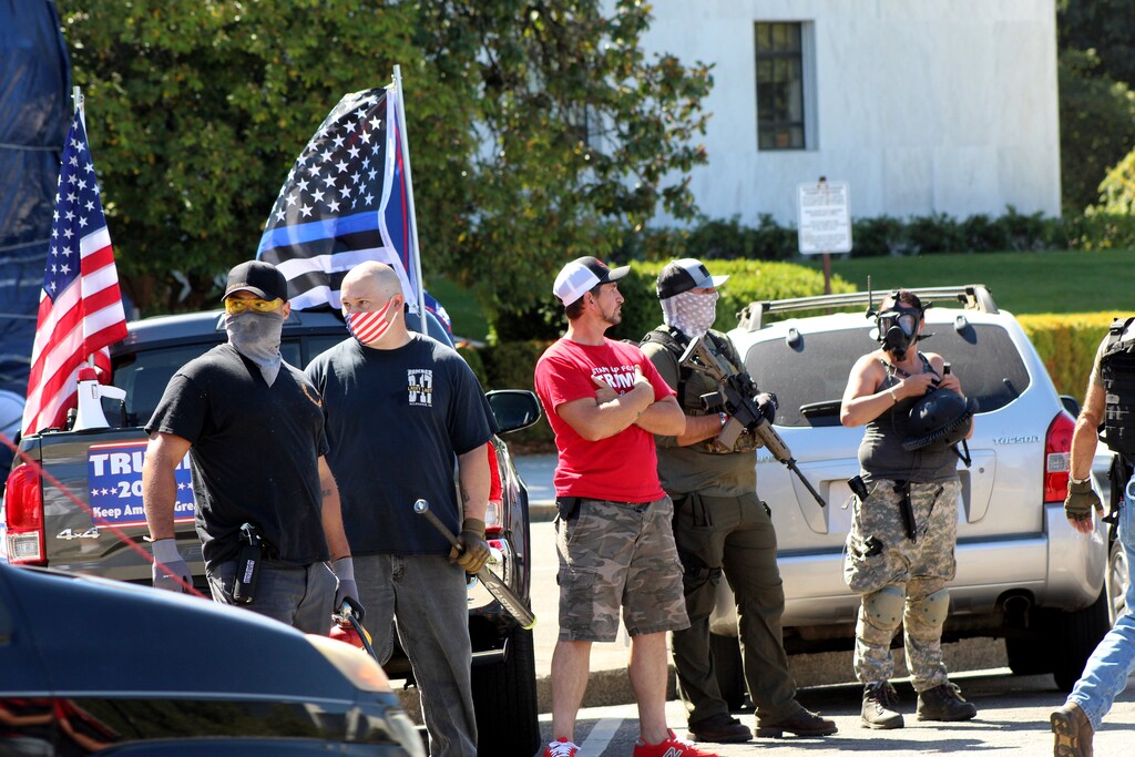 (Andrew Selsky | AP filephoto) Armed right-wing protesters in support of President Donald Trump stand in front of the Oregon State Capitol in Salem, Ore., Monday, Sept. 7, 2020. Hundreds of people gathered on Labor Day in a small town south of Portland for a pro-President Donald Trump vehicle rally, just over a week after member of a far-right group was fatally shot after a Trump caravan went through Oregon's largest city. Later, pro-Trump supporters and counter-protesters clashed at Oregon's Capitol.
