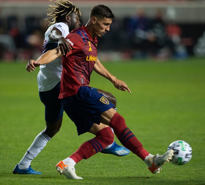 (Rick Egan  |  The Salt Lake Tribune)  Real Salt Lake midfielder Damir Kreilach (8) kicks the ball as Vancouver Whitecaps forward Cristian Dajome (11) defends, in MLS soccer action between Real Salt Lake and the Vancouver Whitecaps at Rio Tinto Stadium on Saturday, Sept. 19, 2020.

 