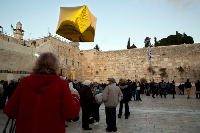 Holocaust survivors stand at the Western Wall, the holiest site where Jews can pray in Jerusalem, Thursday, Dec. 14, 2017. (AP Photo/Sebastian Scheiner)