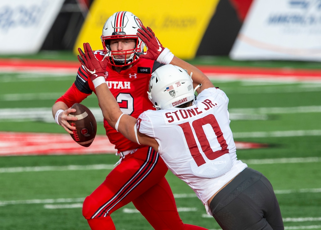 (Rick Egan | The Salt Lake Tribune) Utah Utes quarterback Drew Lisk (12) scrambles as Washington State Cougars defensive end Ron Stone Jr. (10) defends, in PAC-12 football acton between Utah Utes and Washington State Cougars at Rice-Eccles Stadium on Saturday, Dec. 19, 2020.