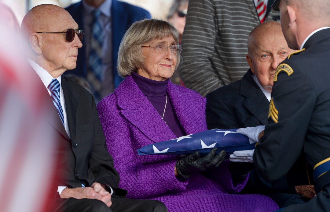 (Leah Hogsten  |  The Salt Lake Tribune) l-r Max LowerÕs brother-in-law Rulon Boyd Maughan, sister Helen Lower Simmons and brother Samuel Steven Lower as Helen is given the honorary Amerian flag. World War II airman Max W. Lower is buried with full military honors and a military aircraft flyover on Saturday, November 23, 2019, the Lewiston City Cemetery, 77 years after he was deployed overseas. Lower, a radio operator on a B-24 Liberator bomber, was killed when the plane was shot down Aug. 1, 1943, over Ploiesti, Romania. The Lewiston native was 23.