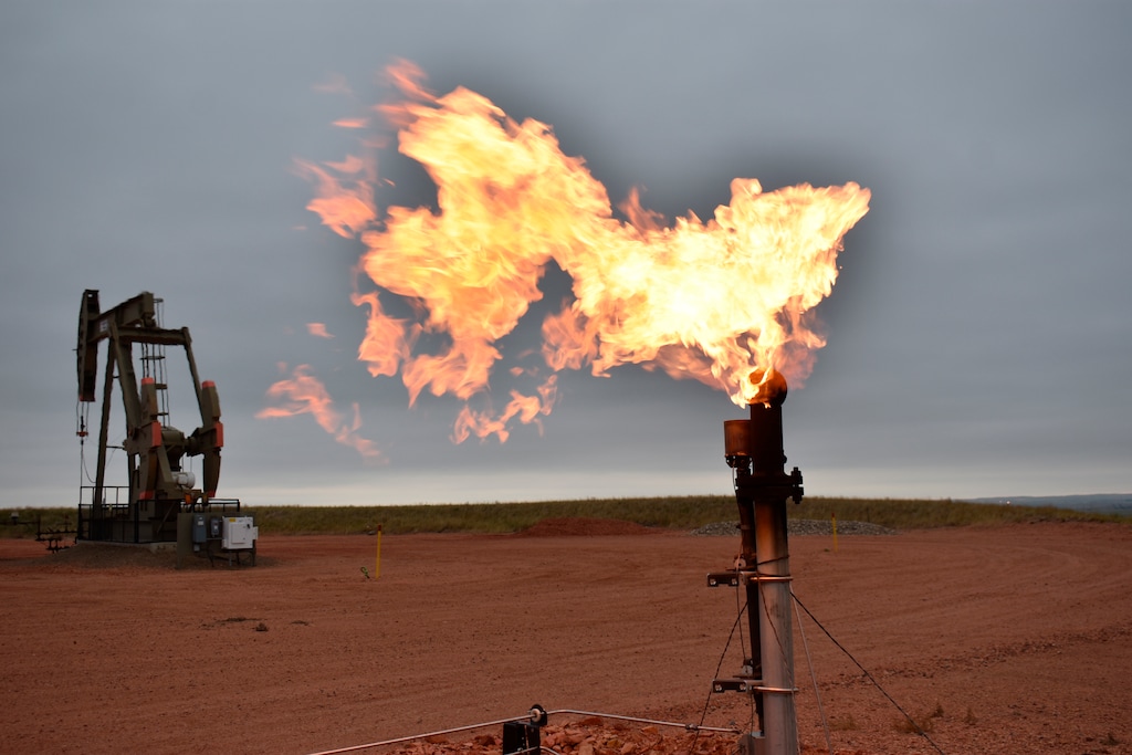 (Matthew Brown | AP) A flare burns natural gas at an oil well, Aug. 26, 2021, in Watford City, N.D. A new report released on Friday found that Utah wasted $48 million worth of natural gas in 2019 due to flaring, venting and leaking gas at production sites.