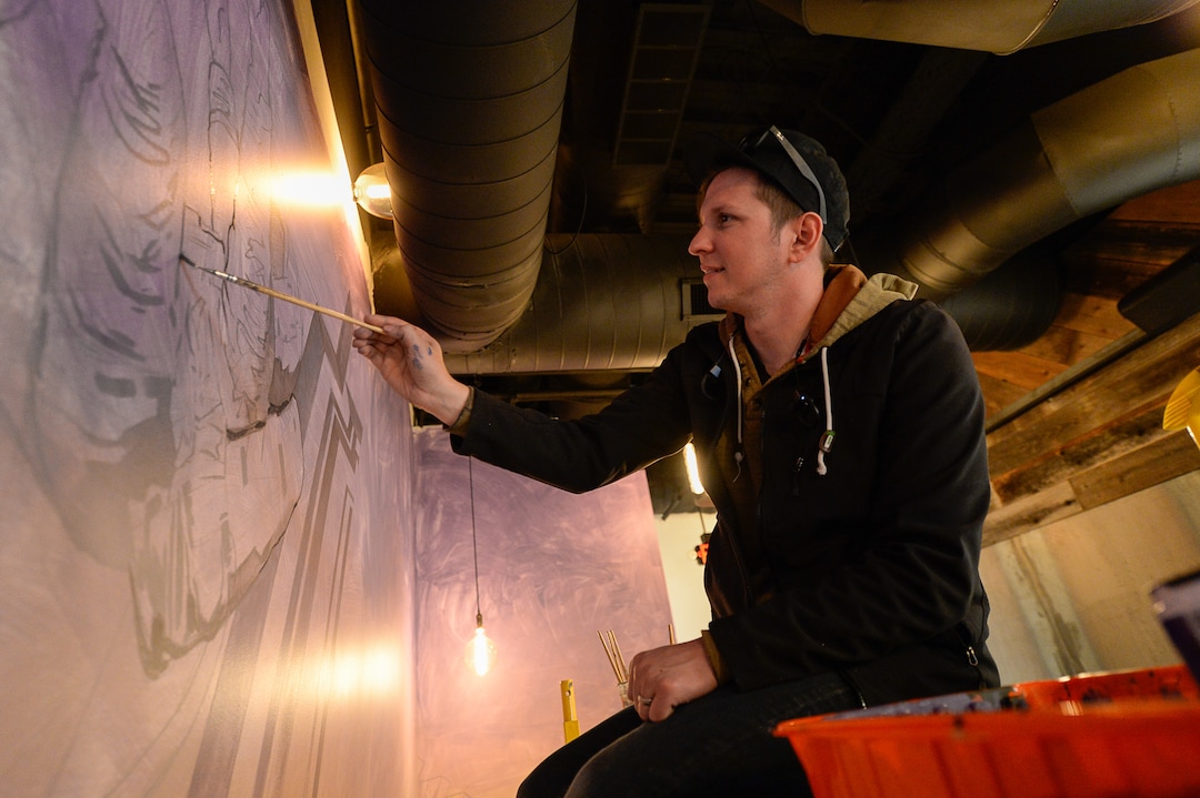 (Francisco Kjolseth  |  The Salt Lake Tribune)  Artist Donovan Fitzgerald works on a mural inside the new food hall at The Gateway called HallPass.