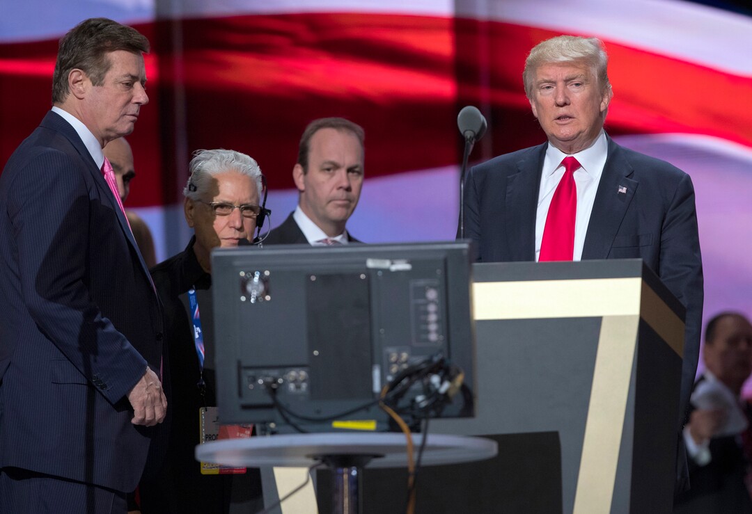 In this July 21, 2016, photo, then-Trump campaign manager Paul Manafort, left, and Manafort's chief deputy Rick Gates, center, watches as then-Republican presidential candidate Donald Trump rehearses for the Republican National Convention in Cleveland. President Donald Trump's former campaign chairman, Manafort, and Gates, a former Manafort business associate, have been indicted on Oct. 30, 2017, on charges of conspiracy against the United States and other counts. (AP Photo/Evan Vucci)