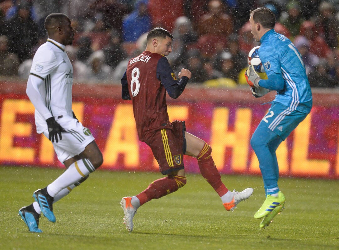 (Francisco Kjolseth  |  The Salt Lake Tribune)  Real Salt Lake midfielder Damir Kreilach (8) nails a shot into Portland Timbers goalkeeper Steve Clark (12) as Portland Timbers defender Larrys Mabiala (33) moves in as Real Salt Lake and the Portland Timbers play in their first MLS playoff game at Rio Tinto Stadium in Sandy, Utah on Saturday, Oct. 19, 2019.