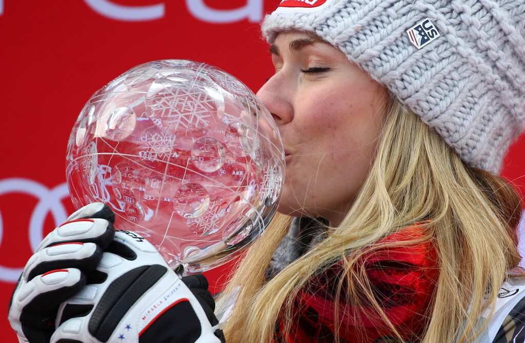 United States's Mikaela Shiffrin kisses the women's World Cup slalom discipline trophy, at the alpine ski World Cup finals in Are, Sweden, Saturday, March 17, 2018.(AP Photo/Marco Trovati)