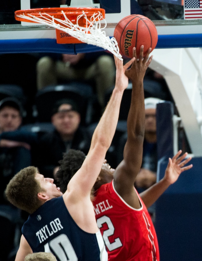 (Rick Egan  |  The Salt Lake Tribune)  Utah Utes guard Kolbe Caldwell (2) shoots as Utah State Aggies forward Quinn Taylor (10) defends, in Beehive Classic basketball action at the Vivint SmartHome Arena, Saturday, December 9, 2017.