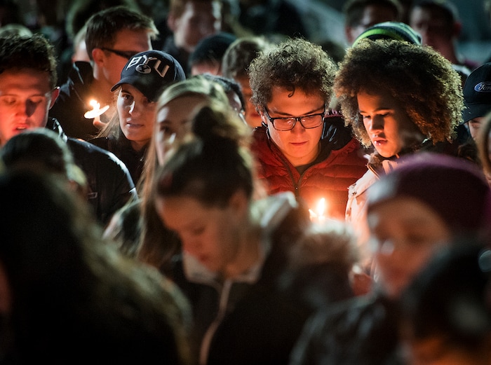 Michael Mangum  |  Special to the Tribune

Issa McKnight, top right, and Adam Meadows, second from right, sing hymns with other students during a candlelight vigil held outside the N. Eldon Tanner Building on the campus of BYU in Provo, UT on Wednesday, December 5th, 2018.