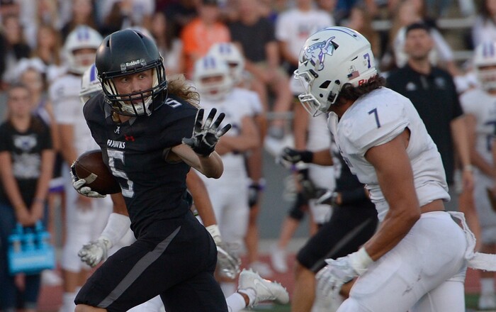 (Leah Hogsten  |  The Salt Lake Tribune) Alta's London Rockwood pushes away Lehi's William Overstreet to run into the end zone. Lehi High School leads Alta High School 42-28 during their game, Friday, August 18, 2017 in Sandy. 