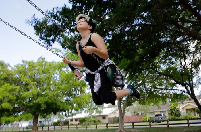 (Lynne Sladky | The Associated Press) In this Thursday, April 28, 2016 photo, Theo Ramos, 14, plays on a swing set at his neighborhood park in Homestead, Fla. Ramos, always a tomboy before he even knew what the word transgender meant, feels more like a boy. But experts agree that any transitioning teen’s journey is difficult and fraught with indecision, anxiety and worry _ by the teens as well as their parents.