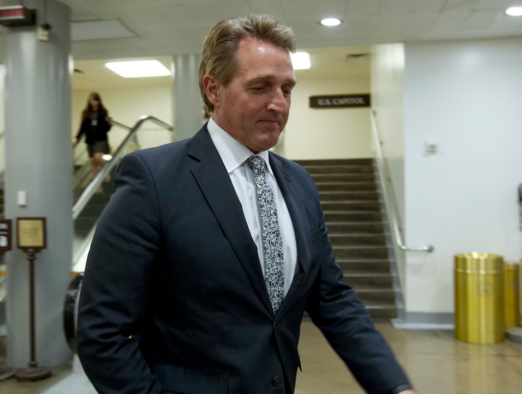 Sen. Jeff Flake, R-Ariz., walks to his office, Thursday, Feb. 8, 2018, at Capitol Hill in Washington. (AP Photo/Jose Luis Magana)