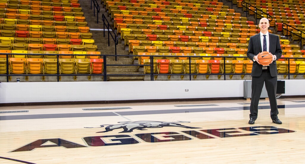 (File photo courtesy USU athletics) Utah State men's basketball coach Craig Smith poses on the court inside the Dee Glen Smith Spectrum in Logan. The Aggies added a game against Northern Colorado to their schedule. The teams meet at 7 p.m. Friday at the Spectrum.