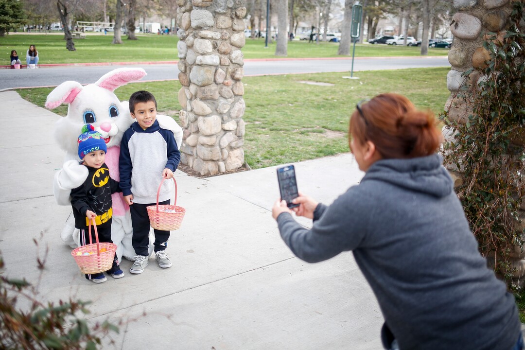 (Nicole Boliaux  |  For The Tribune)  Eva Rivera takes pictures of her sons Michael, right, and left, with the Easter Bunny during the annual Easter egg hunt put on by A Kid's Place Dentistry in Liberty Park in Salt Lake City on Saturday, March 31, 2018.