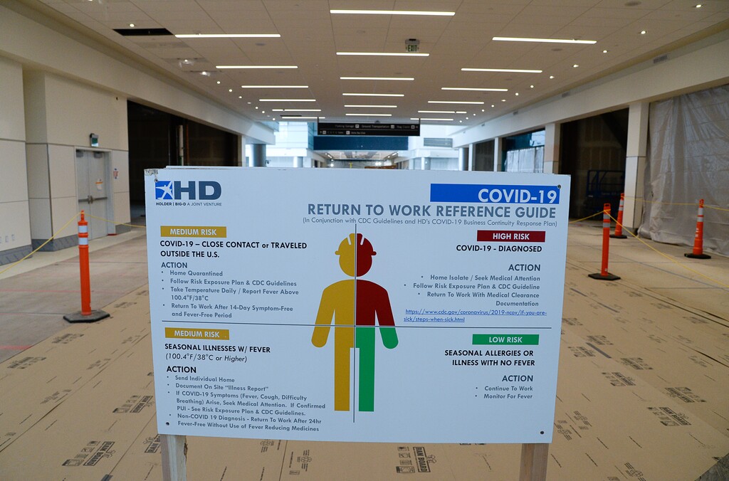 (Francisco Kjolseth  |  Tribune file photo) Signs encouraging social distancing and level of risk are displayed due to the ongoing battle against COVID-19 as crews continue their work in the first phase of construction of the Salt Lake City International Airport on Wednesday, May 20, 2020.