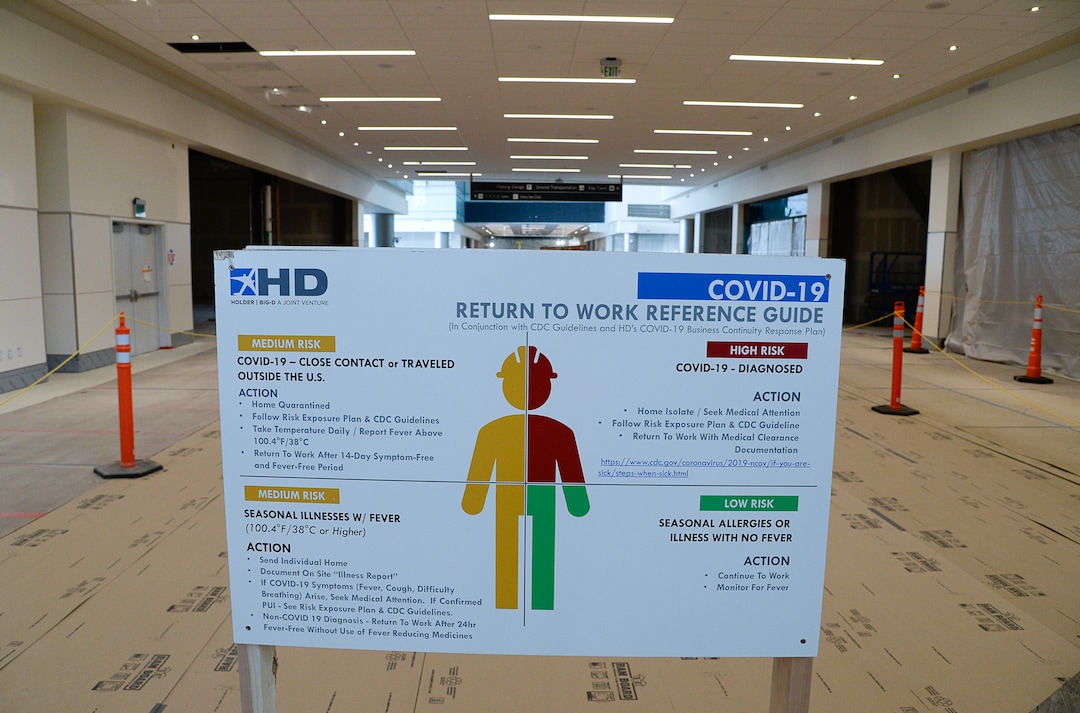 (Francisco Kjolseth  |  The Salt Lake Tribune) Signs encouraging social distancing and level of risk are displayed due to the ongoing battle against COVID-19 as crews continue their work in the first phase of construction of the Salt Lake City International Airport on Wednesday, May 20, 2020.